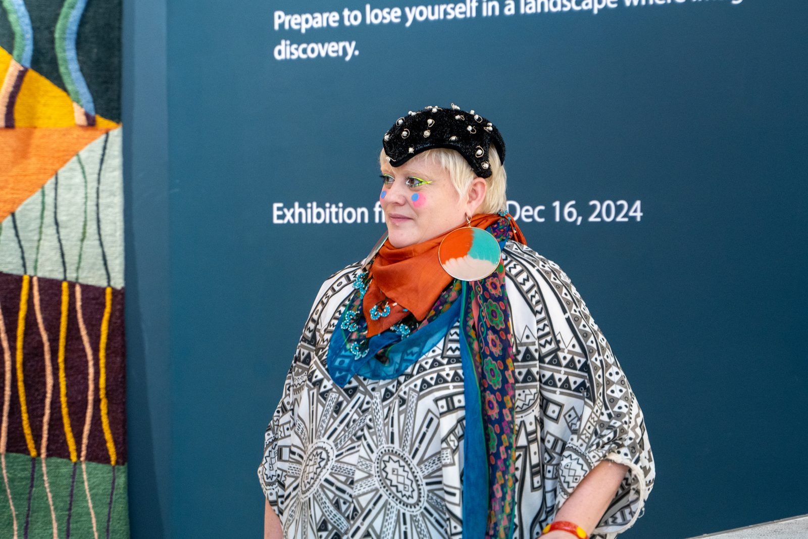 Bethan Laura Wood in front of the exhibition wall
