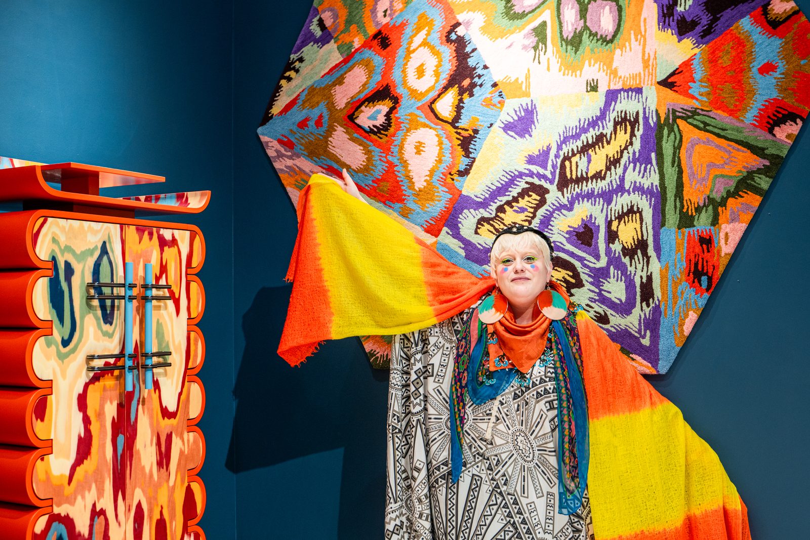 Bethan Laura Wood with the hand-knotted tapestry and cabinet